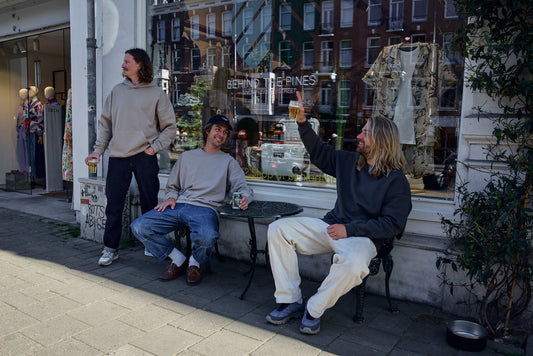 Matthijs, Moran, Miquel wearing Delta collection hoodie and crewneck in front of the behind the pines store