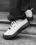 trail running shoe in black white norda behind the pines